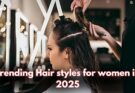 A hairstylist working on a woman’s hair in a modern salon, highlighting trending hairstyles for women in 2025. The text overlay emphasizes the latest styling trends in the beauty industry.